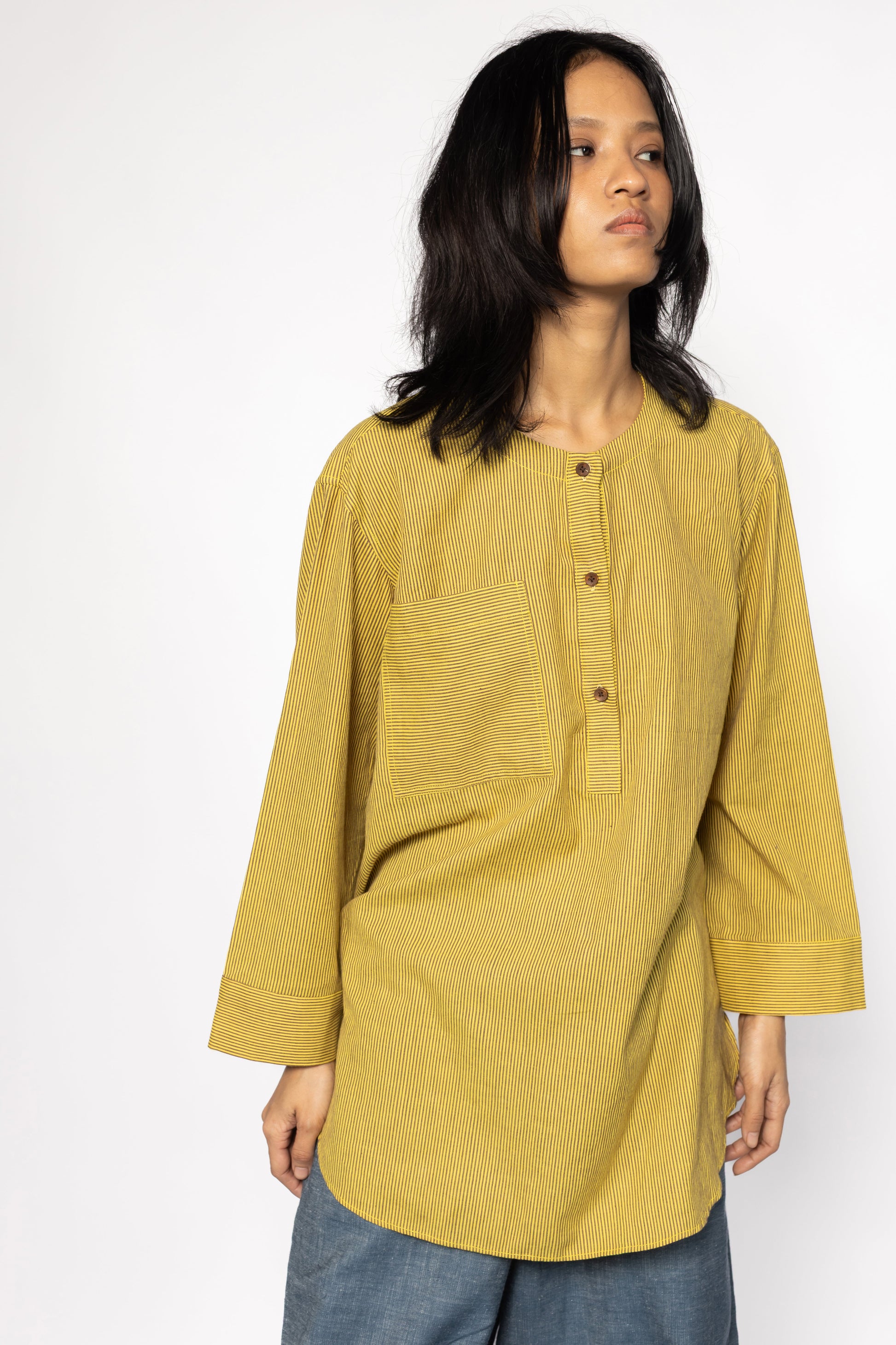 Plains Design - Harvest oversized shirt. Mustard yellow oversized shirt with brown stripes, wooden buttons, and front chest pocket, paired with blue jeans. Ethical fashion. Handmade cotton.
