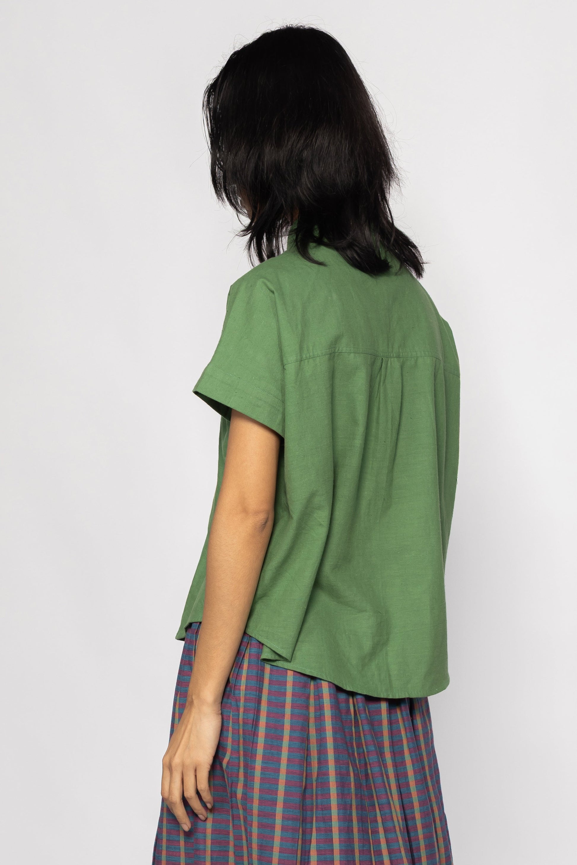 Plains Design - Bud Shirt. Back side of bright green short sleeved shirt in handwoven cotton.