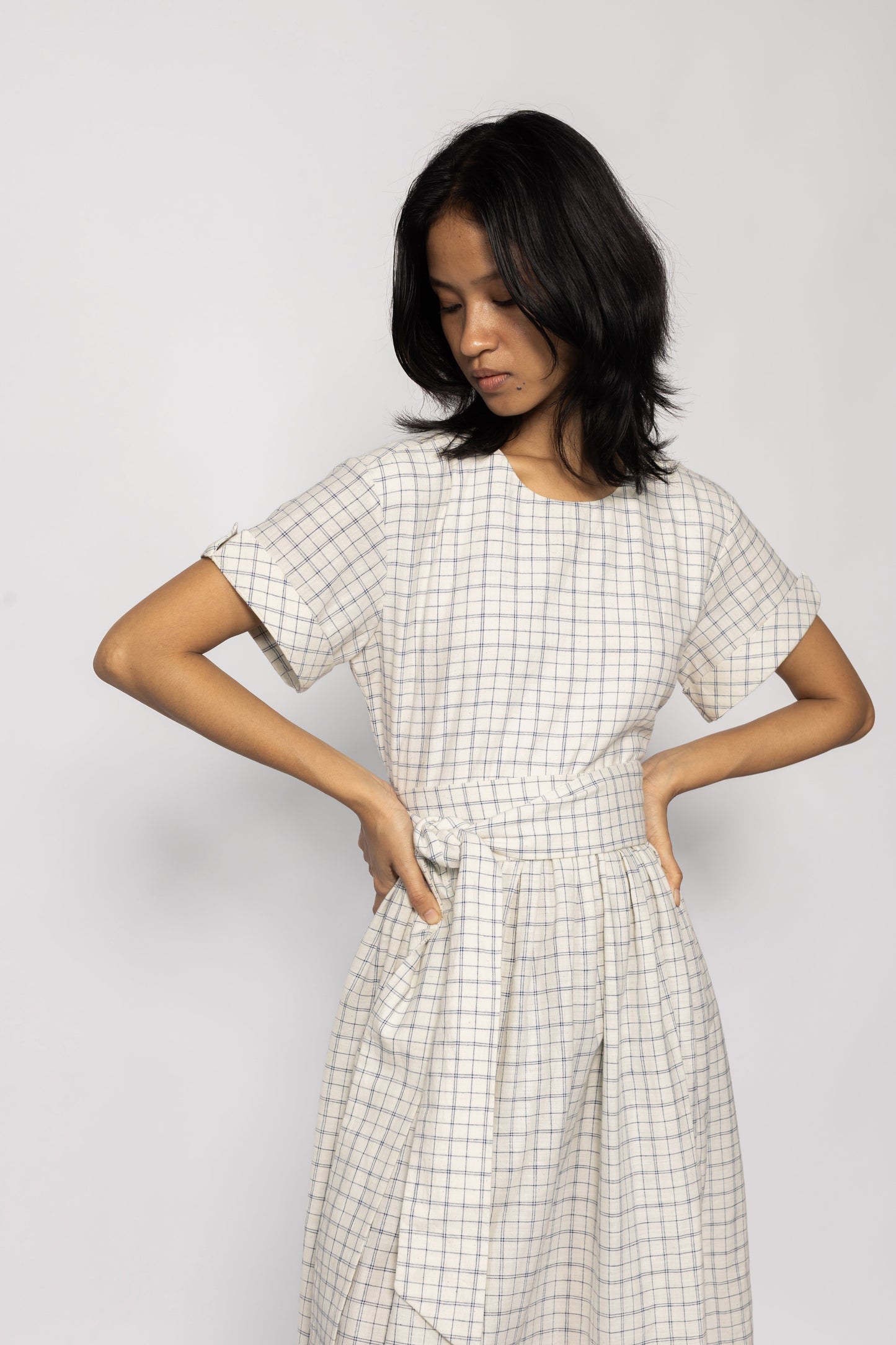 Plains Design Letter Dress - Front close up  of beige checkered dress with detachable cloth belt and short sleeves. Sustainable handmade fashion.