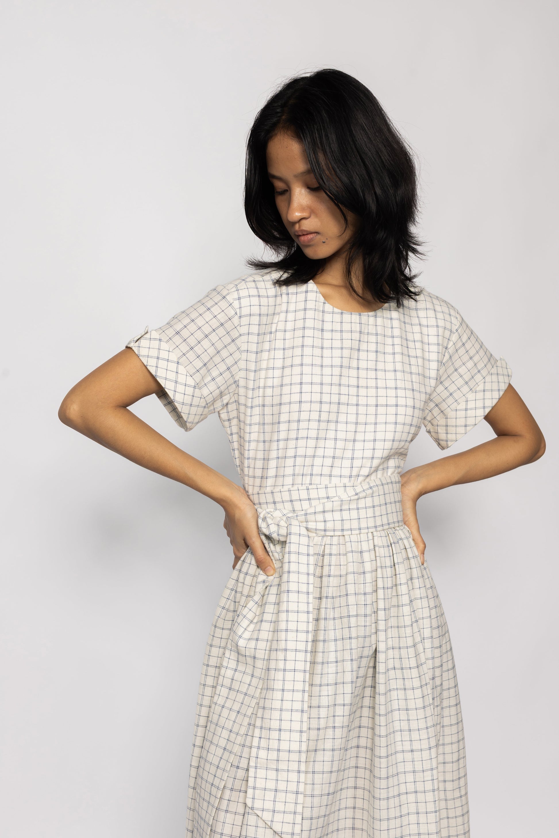Plains Design Letter Dress - Front close up  of beige checkered dress with detachable cloth belt and short sleeves. Sustainable handmade fashion.