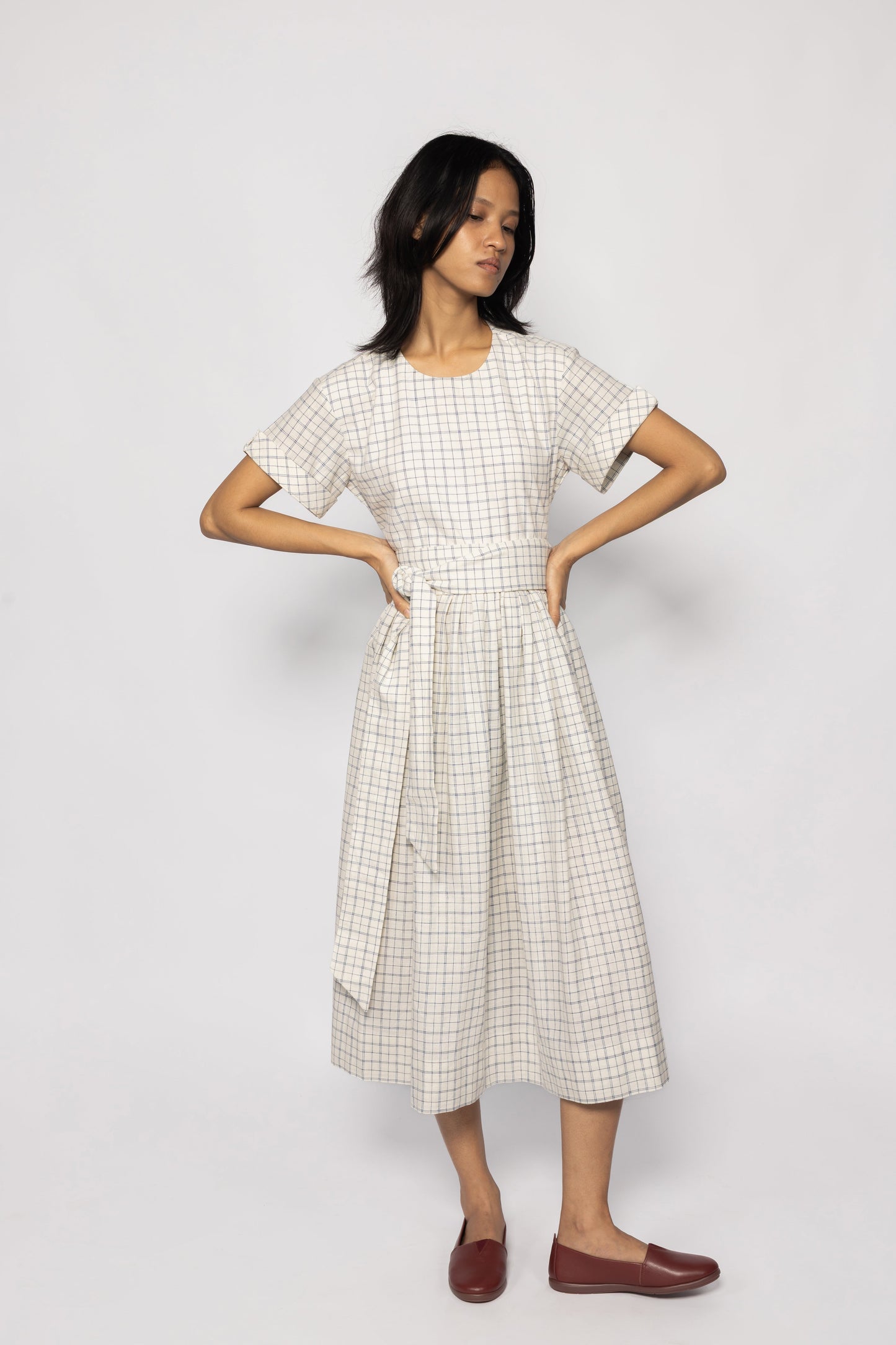 Plains Design Letter Dress - Full length front of model wearing beige checkered dress with detachable cloth belt and short sleeves. Sustainable handmade fashion.